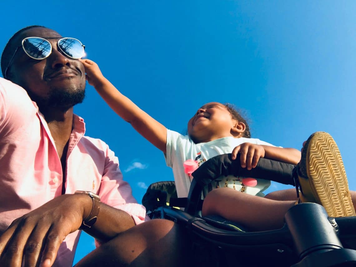 criança e pai brincando com um óculos em um dia de sol